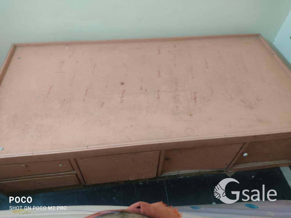 Old single cot with storage space. 